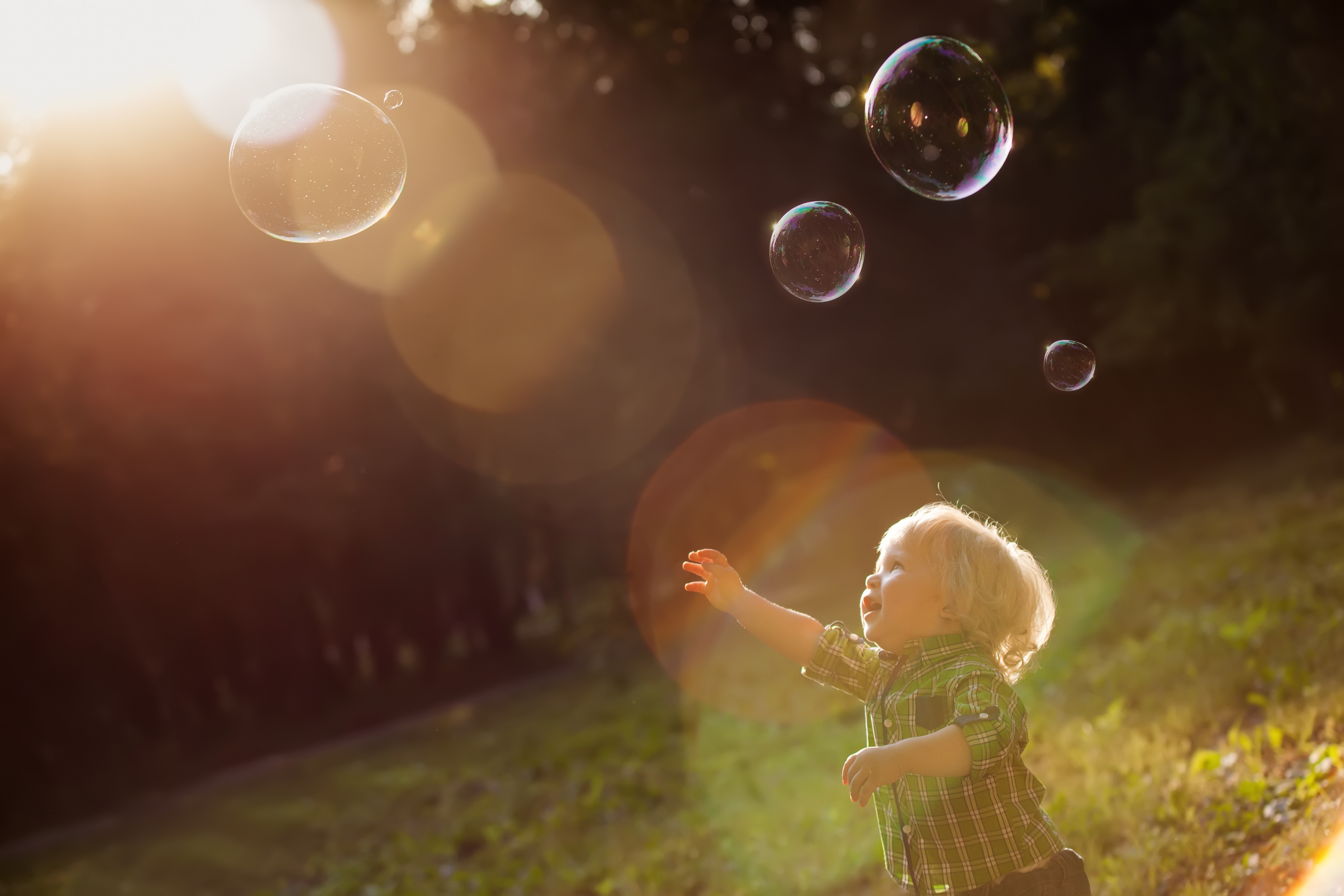 kite-boy-chasing-bubbles-at-park
